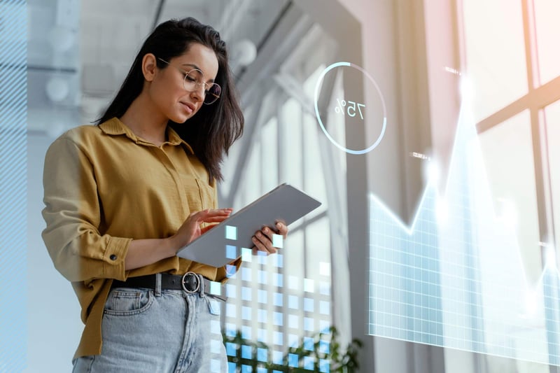 woman holding tablet reviewing predictive analytics
