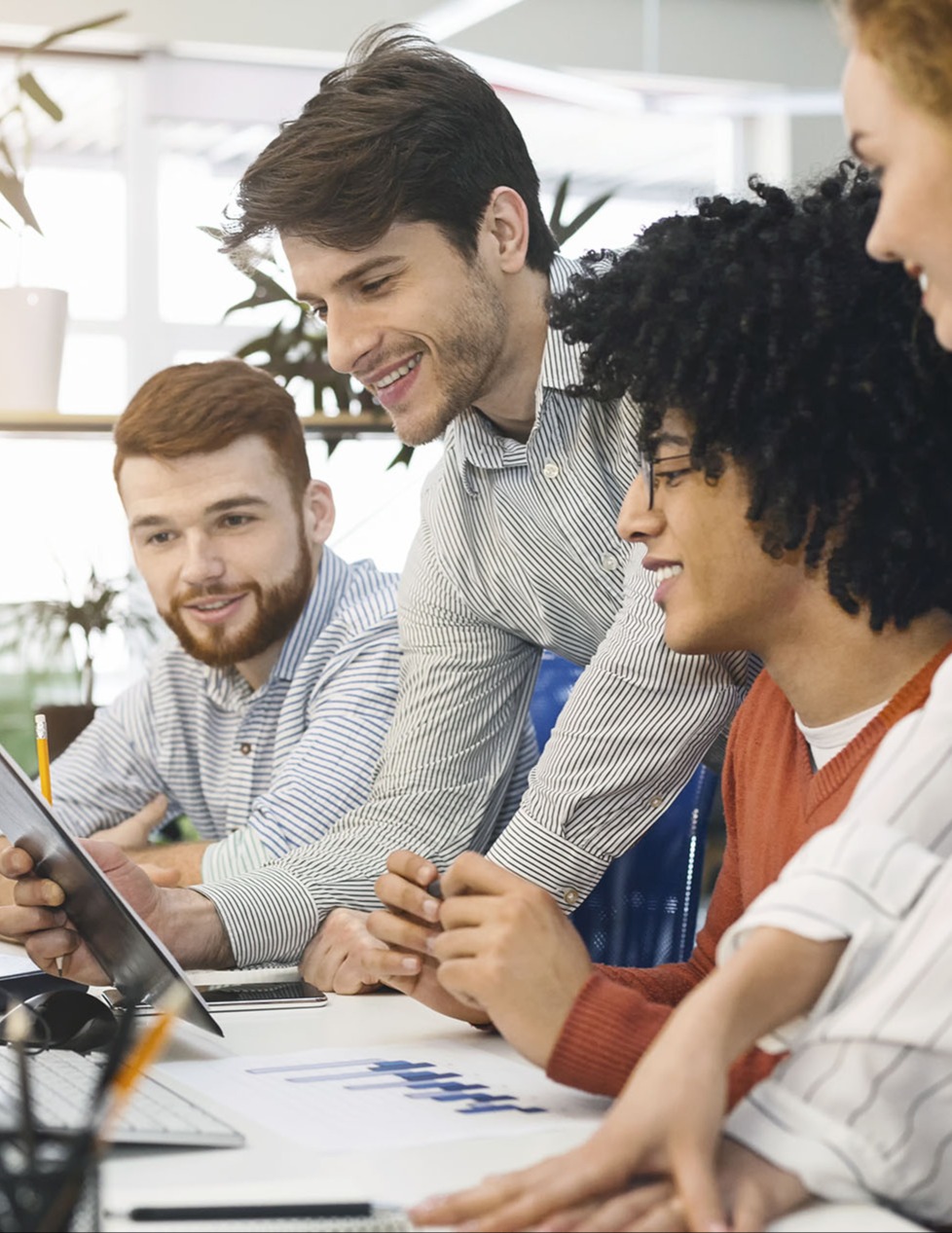 Young team analyzing information on computer screen in office